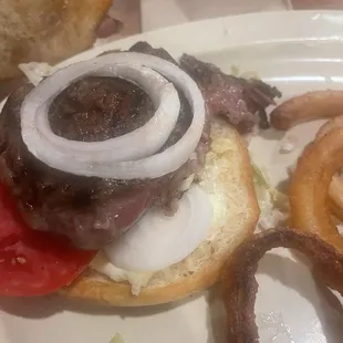 Steak sandwich added lettuce, tomato and onion