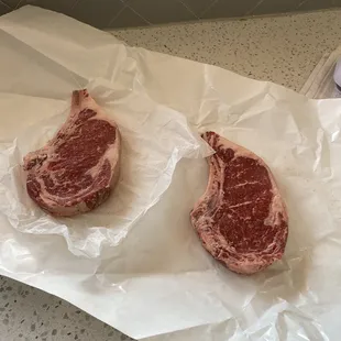 two steaks on a piece of paper