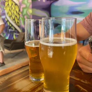 two glasses of beer on a table