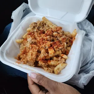 a person holding a container of food
