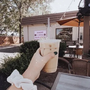 a hand holding a cup of coffee