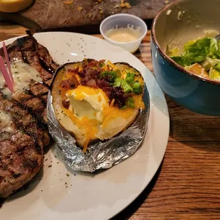 New York Strip (Medium Rare), loaded baked potato, and a side ceaser.