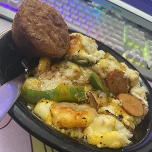 Shrimp and Cheddar Bay Garlic Battered Gulf Shrimp Cheese Grits w/ Andouille Chicken Sausage Sauted Veggies