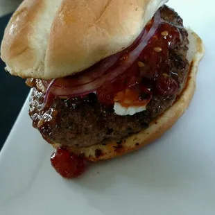 a hamburger on a white plate