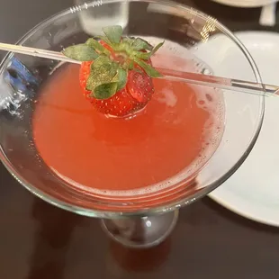 a strawberry in a martini glass