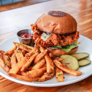 Buffalo Chicken Sandwich with fires and housemade pickles