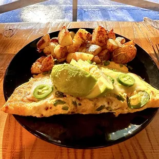 Bacon, avocado, omelet with country potatoes.