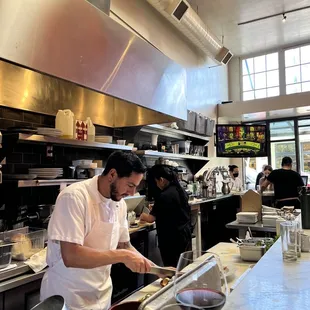 a man preparing food in a restaurant kitchen
