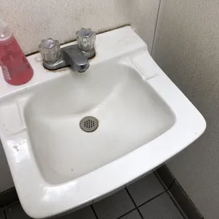 a sink with soap dispenser