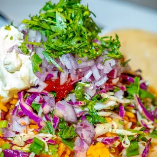 a variety of toppings on top of a tortilla