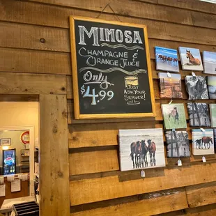 a chalkboard with a sign that says minnesota champagne and orange juice only $ 499