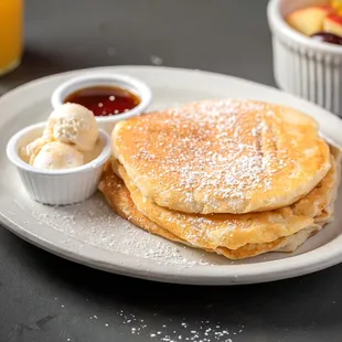 a plate of pancakes with ice cream and fruit