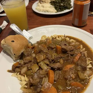 Beef stew with half egg noodles and mashed potatoes, far picture-chicken fried steak.  Coke and Orange Smash drinks.