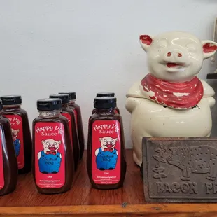 a pig figurine and bottles of bbq&apos;s barbecue sauce