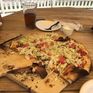 a pizza on a cutting board