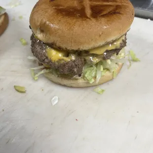 a hamburger with cheese and lettuce