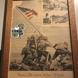 a picture of a group of soldiers raising the flag