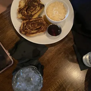 a plate of pancakes, mashed potatoes, and a glass of water
