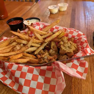 a basket of fried chicken and fries