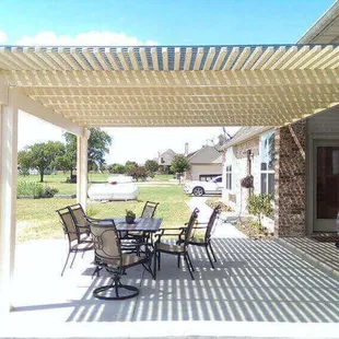 a patio with a table and chairs