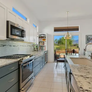 The counter at the far end was extended to the wall, and an additional cabinet, bookcase and built-in wine cooler were added.