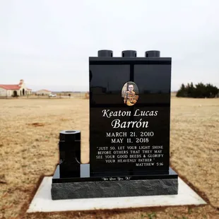 Lego shaped memorial, with a cross vase.