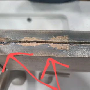 More of what looks like something peeled off.  Maybe when they removed tape after staining?