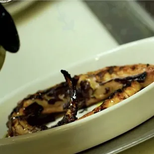 a plate of food being drizzled with olive oil