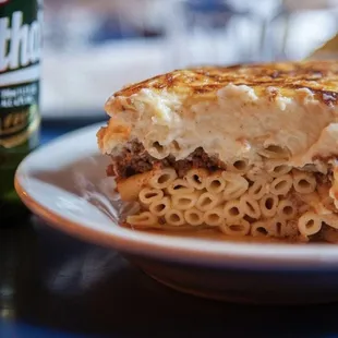 a plate of food and a bottle of beer
