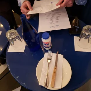 a person sitting at a table with a menu