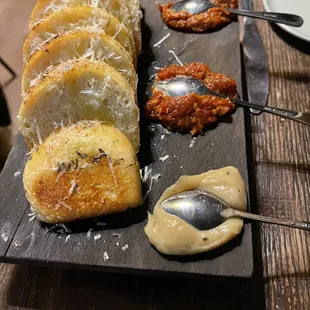 BREAD BOARD rosemary &amp; fennel seed foccocia, olive oil, roasted garlic, calabrian chili and tomato &quot;jam&quot;