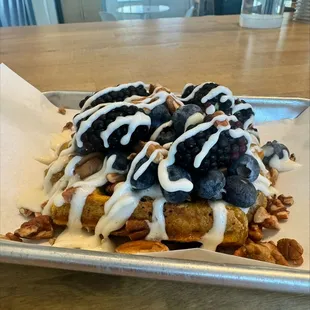 Pumpkin waffle with blackberries, blueberries, pecans and a homemade cream cheese drizzle