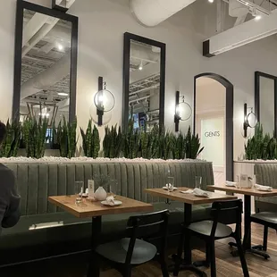 a dining area with tables and chairs