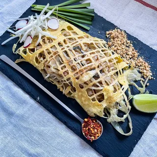 Pad Thai wrapped in egg nest