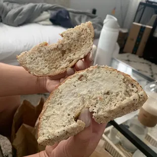 a person holding a piece of bread