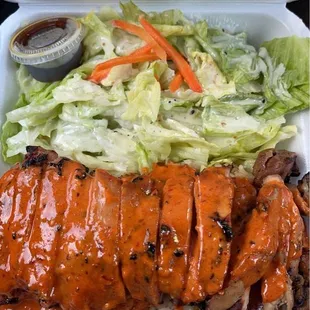 Spicy chicken with rice and salad.