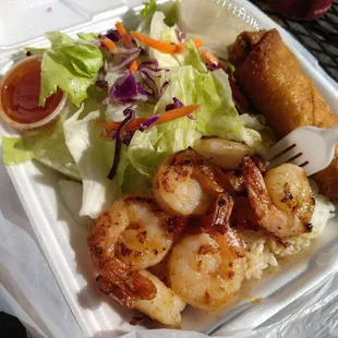 shrimp, rice, and salad in a styrofoam container