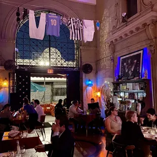 people sitting at tables in a restaurant