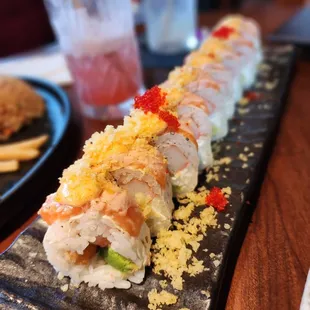 a sushi roll on a black plate