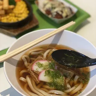 a bowl of ramen with chopsticks