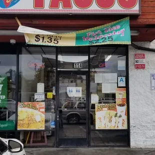 a car parked in front of a taco shop