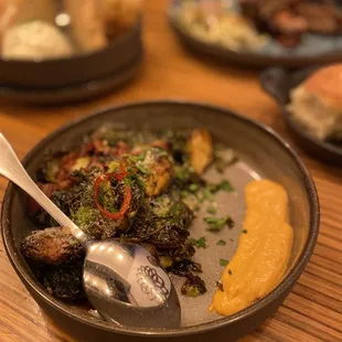 Brussels Sprouts $11.00 crispy bacon, calabrian chili aioli, agave, candied fresno chili, parmigiano reggiano