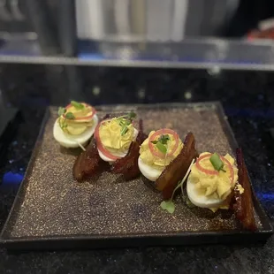 Deviled eggs with candied bacon