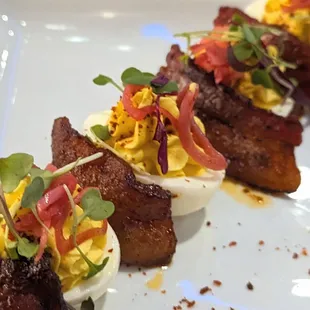 Deviled Eggs Appetizer: the bacon was delicious and we loved the beautiful plating and garnish.