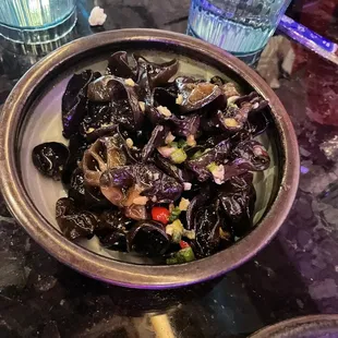 a bowl of mussels and vegetables
