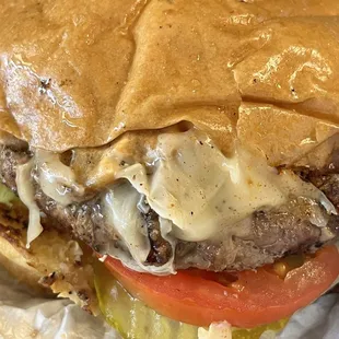 a closeup of a hamburger with cheese and lettuce