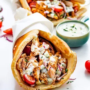 Chicken Gyro
made with tender flavored chicken, lettuce, tomatoes, onions, and a tangy siracha sauce, all wrapped in a warm pita.