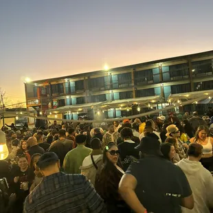 a large crowd of people gathered outside a building