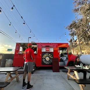 a man standing in front of a food truck