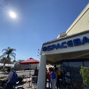  people standing outside of a restaurant